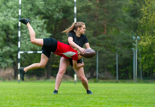Girls playing rugby together outside in summer. Woman sport concept - Powered by Adobe