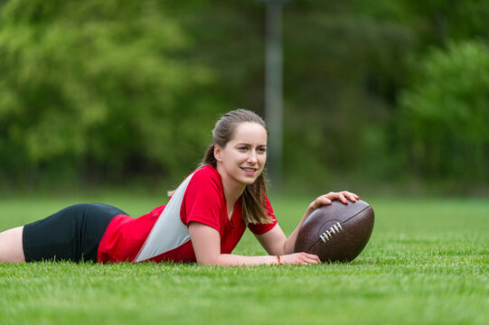 Girl playing rugby together outside in summer. Woman sport concept