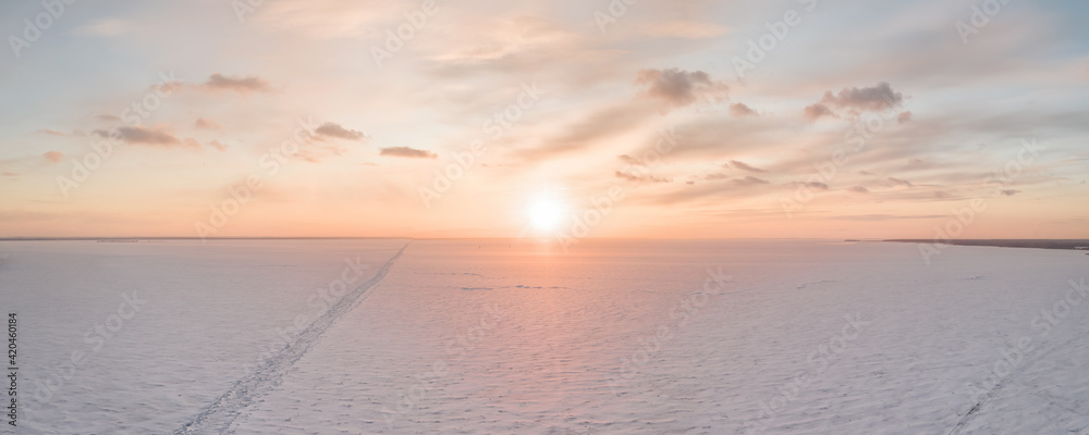 Wall mural ice on the frozen sea and bright colored sky at sunset - Wall murals