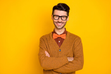 Portrait of attractive cheerful glad guy mc hipster folded arms isolated over bright yellow color...