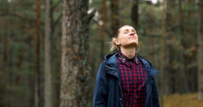 woman take a deep breath and enjoy the nature in forest. meditation and stress relief