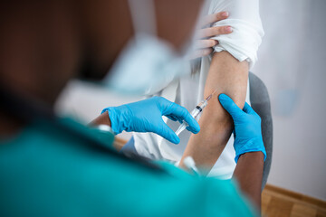 Close up of a Doctor making a vaccination in the shoulder of patient, Flu Vaccination Injection on...