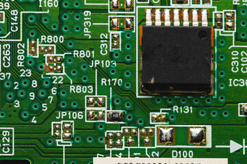 Green electronic board with radioelements close-up. Background for the theme of electronics and high tech equipment