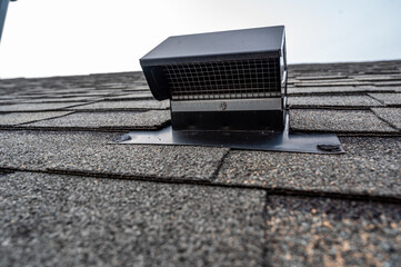 Static vent installed on a shingle roof for passive attic ventilation © Lost_in_the_Midwest