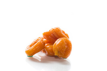 delicious dried apricots in a bowl on white background