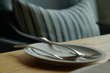 Soft Focus Fork and spoon on a plate on wooden desk