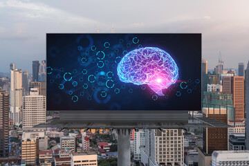 Brain hologram on billboard with Kuala Lumpur cityscape background at sunset. Street advertising poster. Front view. KL is the largest science hub in Malaysia, Asia. Coding and high-tech science.