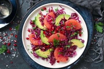 Red cabbage salad with avocado, grapefruit and pomegranate. Diet food. Top view.