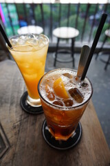 Coffee and orange juice on wooden table in cafe