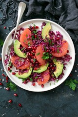 Red cabbage salad with avocado, grapefruit and pomegranate. Diet food. Top view.