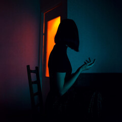 Portrait of woman in color light. Dark mood concept