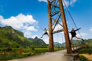 Fototapeta na wymiar Couple on bridge Phong Nha Vietnam