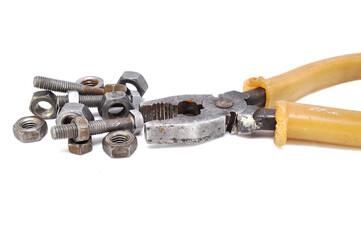 Rusty pliers bolts and nuts on white background close up