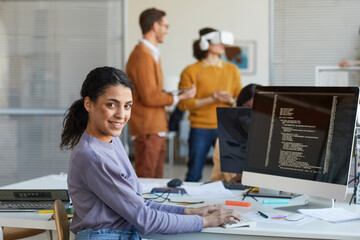Ethnic Young Woman Programming Software in Office