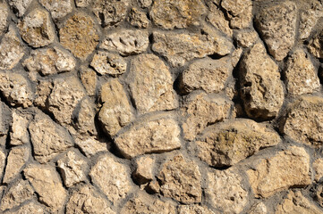 Decorative wall made of natural stone of various shapes and sizes. Interior background