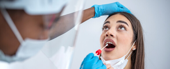 Female caucasian doctor holding a swab collection stick, nasal and oral specimen swabbing in...
