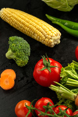 Carrots and vegetables on black background in studio