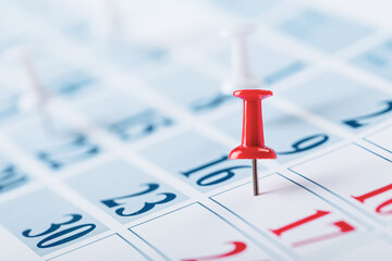 Calendar page for 2021, a month marked with an important date with a pin. chronology, time, concept