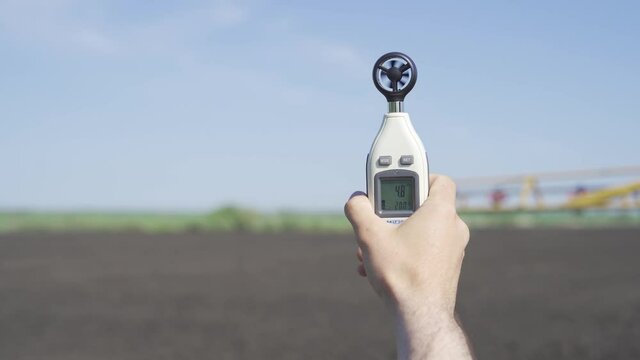 anemometer in the hand of man, which measures wind speed