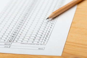 testing in exercise and exam paper. computer sheet with pencil in school test room, education concept. filling in answers in pencil