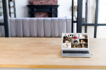 Many portraits faces of diverse young and aged people webcam view, laptop on the desk, empty space, while engaged in videoconference on-line meeting, group video call application easy usage concept