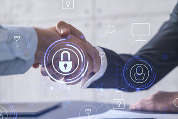 Handshake of two businessmen who enters into the contract to protect cyber security of...
