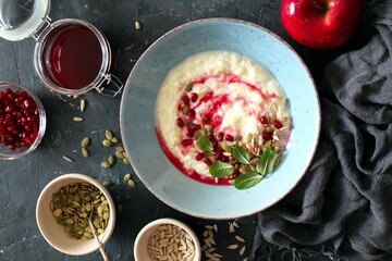 Apple yogurt with pumpkin, sunflower seeds and pomegranate. Healthy breakfast for children and adults. Top view with copy space.