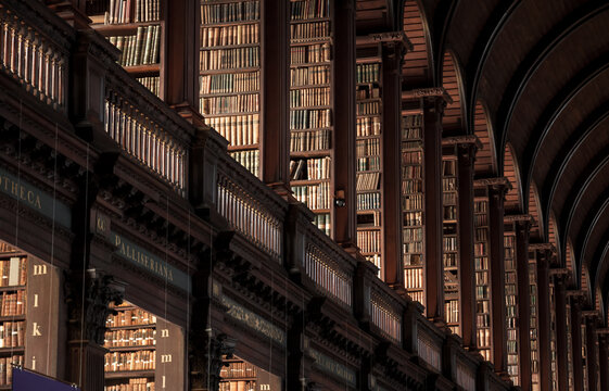 Trinity College vintage library with shelves of old books in the Long Room in Dublin, Ireland
