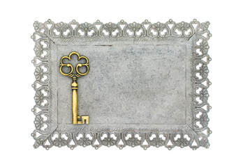 Decorative key with carved patterns of metal frame on a white background