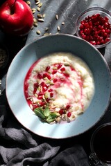 Apple yogurt with pumpkin, sunflower seeds and pomegranate. Healthy breakfast for children and adults. Top view with copy space.