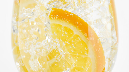 cold Refreshing water. drink with orange, sparkling water and ice, closeup