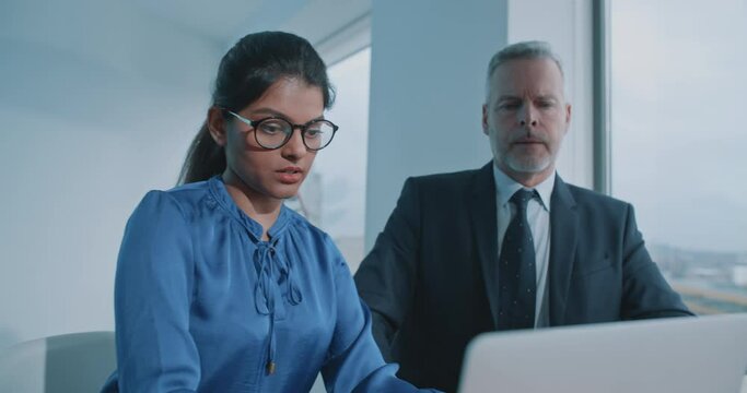 Young Indian woman presenting a project to a colleague