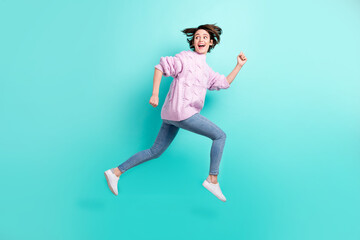Fototapeta na wymiar Full length photo of funky funny lady dressed purple pullover jumping running looking back empty space isolated teal color background