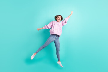 Fototapeta na wymiar Full length photo of excited pretty young lady dressed purple pullover jumping catching isolated teal color background