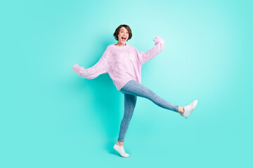 Full length photo of sweet charming young lady dressed purple pullover dancing walking isolated teal color background