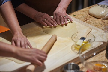 Fototapeta na wymiar kneading, forming, rolling with a rolling pin