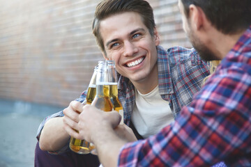 Group of young friends having fun with beer at street.