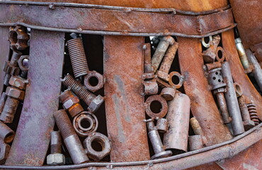 Welded steel elements (bearings, bolts, plates, nuts, bushings, studs, etc.) into the overall structure, covered with rust close-up