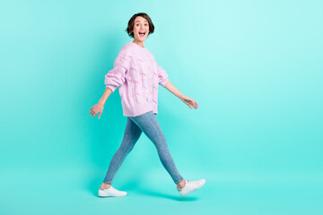 Full length photo of adorable impressed young lady dressed purple pullover walking open mouth isolated teal color background