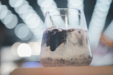 Iced cocoa mix with milk in glass.