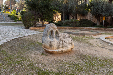 Evening view of an abstraction-style sculpture with an urban public park in the old Jerusalem...