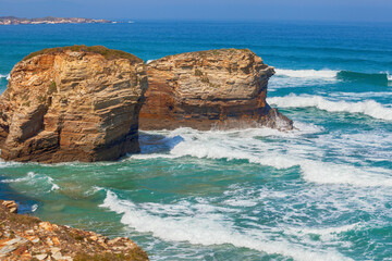 Seascape on a sunny day. Rocky sea coast on the Beach Playa de Las Catedrales in Ribadeo, Galicia, Spain, Europe