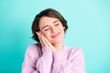 Photo of charming sweet young lady dressed purple pullover arms cheek closed eyes isolated teal color background