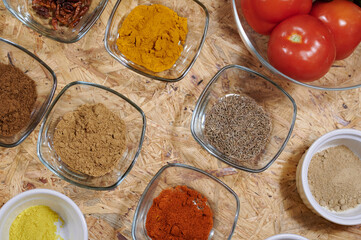 Kitchen, spices in glass dishes. Turmeric, chilli, cumin, pepper, and curry