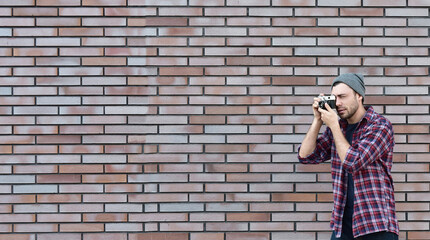 Say cheese, hipster fashion photographer man holding retro camera
