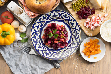 Vegan vegetable salad vinaigrette with beetroot, green peas and boiled potatoes