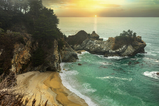 McWay Falls in Big Sur, a beautiful landscape on the Pacific coast of California, light fog. Concept picture for postcards, tourist guide and travel guide.