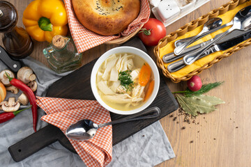 Chicken broth with noodles, carrots and dill