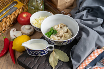 A portion of boiled dumplings with sour cream
