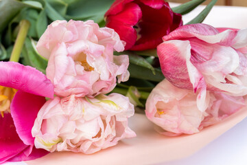 Fresh bouquet of pink bright tulips on a white background. Suitable for postcards, articles about the holidays, wedding invitation. close-up, selective focus.